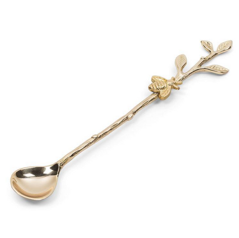 Gold spoon with leaf design on a white background