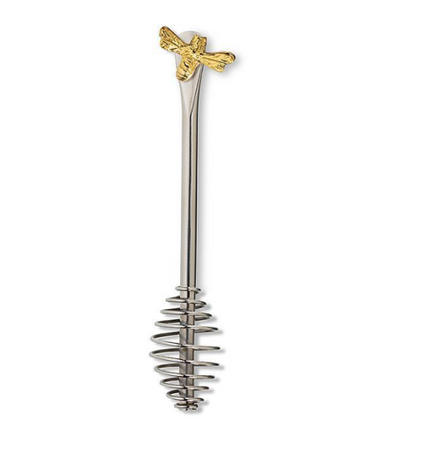 Metallic stirrer with gold bee on top on a white background