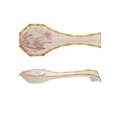 A ceramic spoon showing different sides with decorative handles on a white background