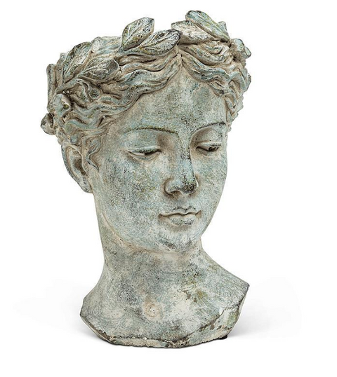 Statue of a woman's head with an olive wreath on a white background