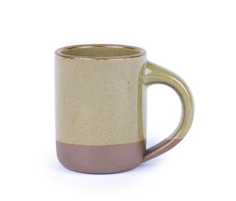 Green ceramic mug with brown accent on a white background