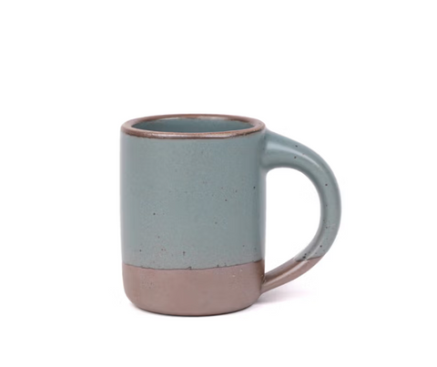 Two-tone ceramic mug with a gradient from green to brown on a white background