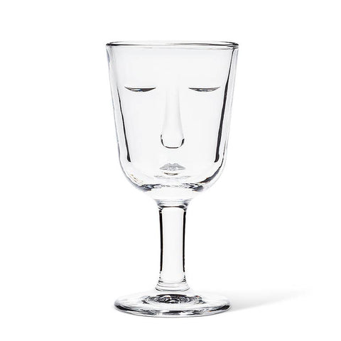 Clear glass wine glass with a face design on a white background