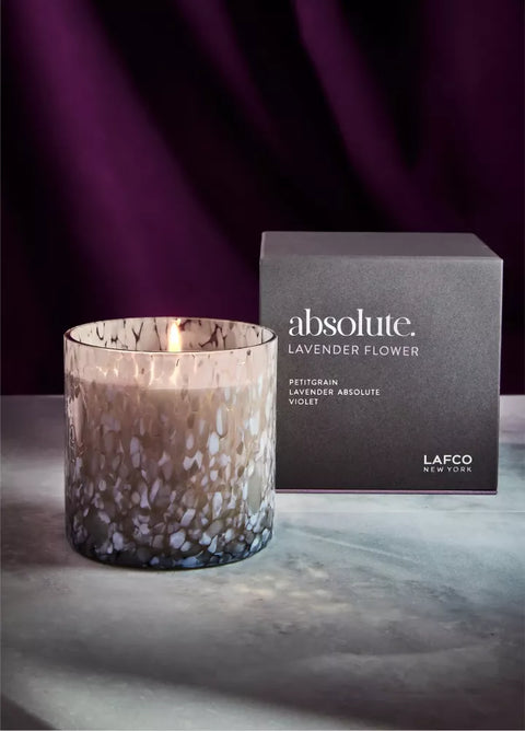 Candle and packaging of 'absolute. Lavender Flower' by Lafco on a dark background