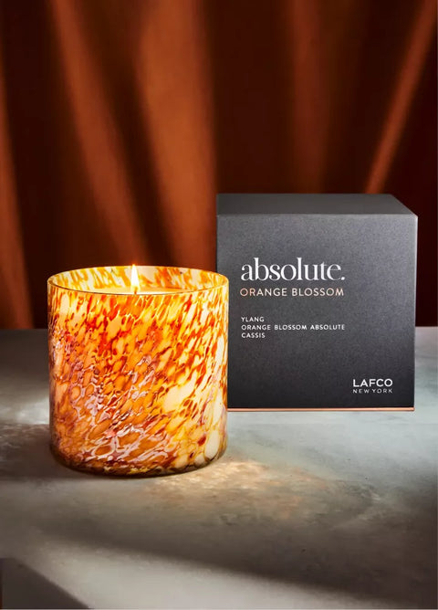 Orange and white marbled candle with 'absolute' box in the background