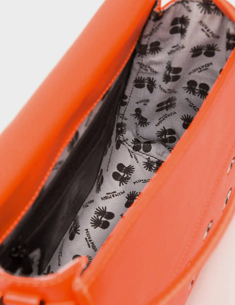 Close-up of an orange bag with a black and white patterned interior.