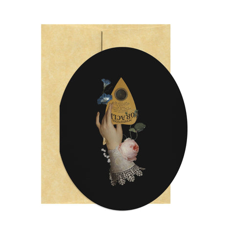 Greeting card with a hand holding a vintage-style perfume bottle and flowers on a black circle with beige border.