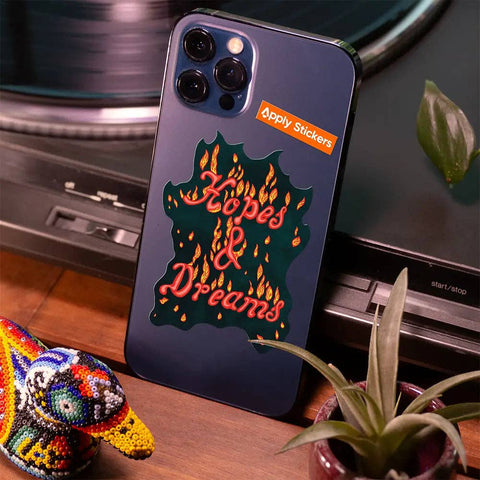 Phone case with 'Hopes & Dreams' design on a table with a plant and decorative object.