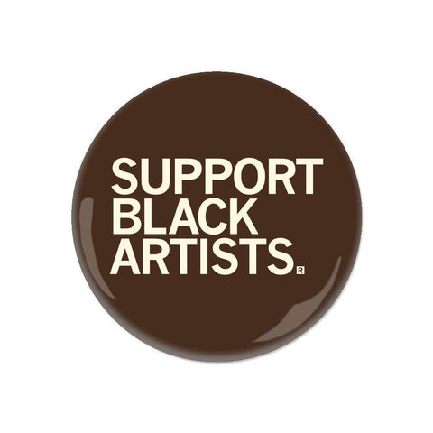 Brown pin with a phrase "Support Black Artists" on a white background