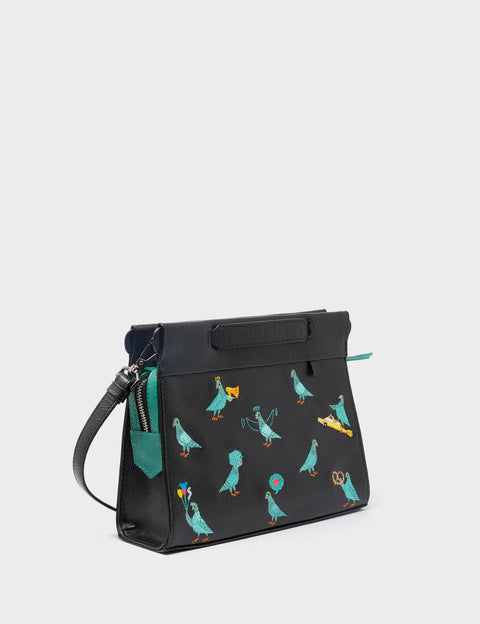 Black handbag with colorful bird patterns on a light gray background