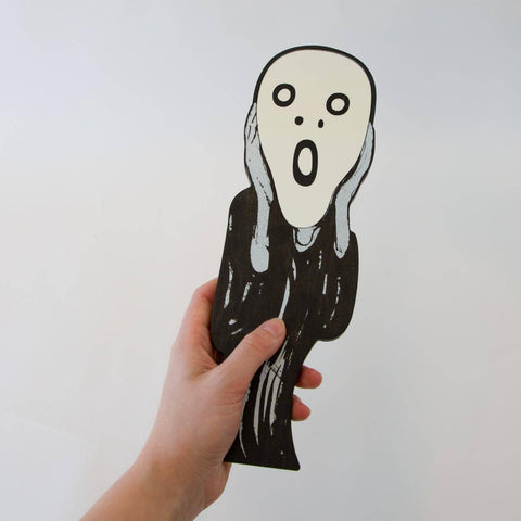 Black and white illustration of "The Scream" with a surprised expression on a white background and a hand holding it.