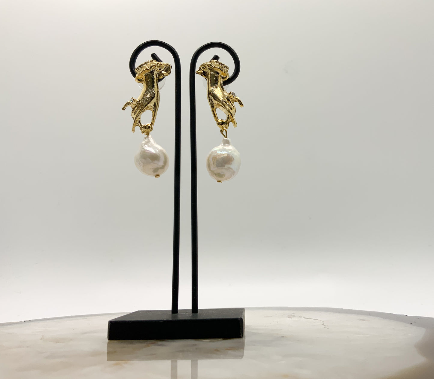 Hand Holding Baroque Pearl Earring