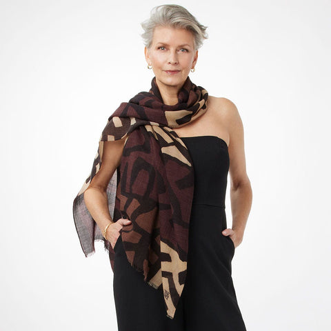 Woman wearing a patterned scarf on a white background