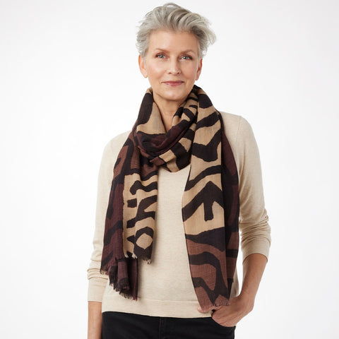 Woman wearing a patterned scarf on a white background