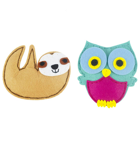 Plush toy sloth and owl on a white background