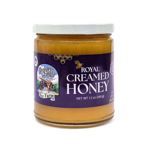 Jar of Royal Creamed Honey with a purple label on a white background