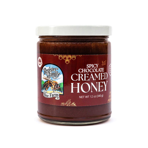 Jar of spicy chocolate creamed honey with a label on a white background